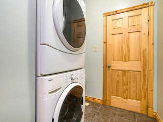 This laundry room features a modern stacked washer and dryer set, perfect for efficient laundry days.