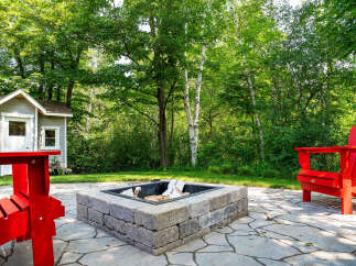 Enjoy the tranquility of this outdoor oasis! This property features a charming fire pit, perfect for cozy evenings.