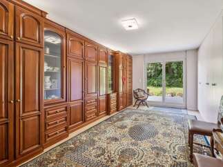 Step into luxury with this stunning property, featuring exquisite built-in wooden cabinetry that exudes timeless elegance.