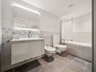 Step into this modern bathroom, featuring sleek design and high-end finishes.