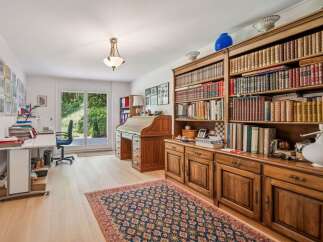 Step into a world of refined elegance with this stunning property, featuring a dedicated home office space.