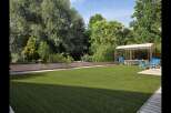 Enjoy outdoor living in this beautifully landscaped backyard featuring a pristine artificial lawn perfect for recreation.