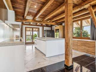 This stunning kitchen boasts a rustic charm with its exposed wooden beams and elegant design.