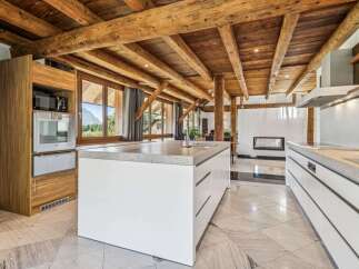 Experience luxury living in this stunning kitchen, featuring a modern design with a touch of rustic charm.