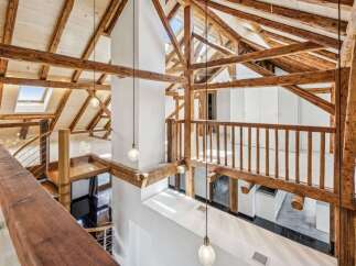Experience the charm of this stunning property, showcasing a unique architectural design with exposed wooden beams and a soaring ceiling.