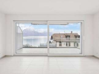 Experience breathtaking views from this stunning property! This home features expansive windows that frame a picturesque landscape, including a serene lake and majestic mountains.