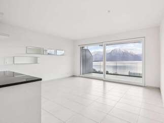 Experience breathtaking views from this modern apartment featuring expansive windows and a private balcony.