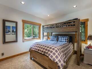 This cozy bedroom features a rustic bunk bed, perfect for accommodating guests or family.