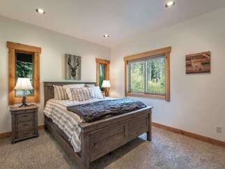 This cozy bedroom features a rustic wooden bed frame and matching nightstands, creating a warm and inviting atmosphere.
