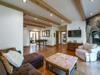 This stunning property boasts a spacious living area with a cozy fireplace, perfect for relaxing evenings.