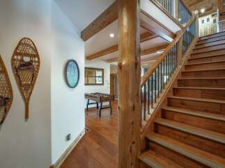 Step into luxury with this stunning property featuring a grand staircase and exquisite wooden accents.