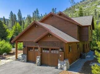 Nestled in a serene natural setting, this stunning property boasts a beautiful wooden exterior and a charming design.