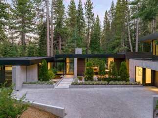 This stunning modern home seamlessly blends with its natural surroundings, offering a tranquil retreat.