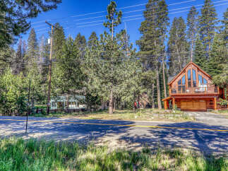 Nestled amidst towering trees, this stunning cabin offers a serene escape.