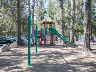 Enjoy family fun at this beautiful park! This property features a playground with a slide and swings, perfect for kids.