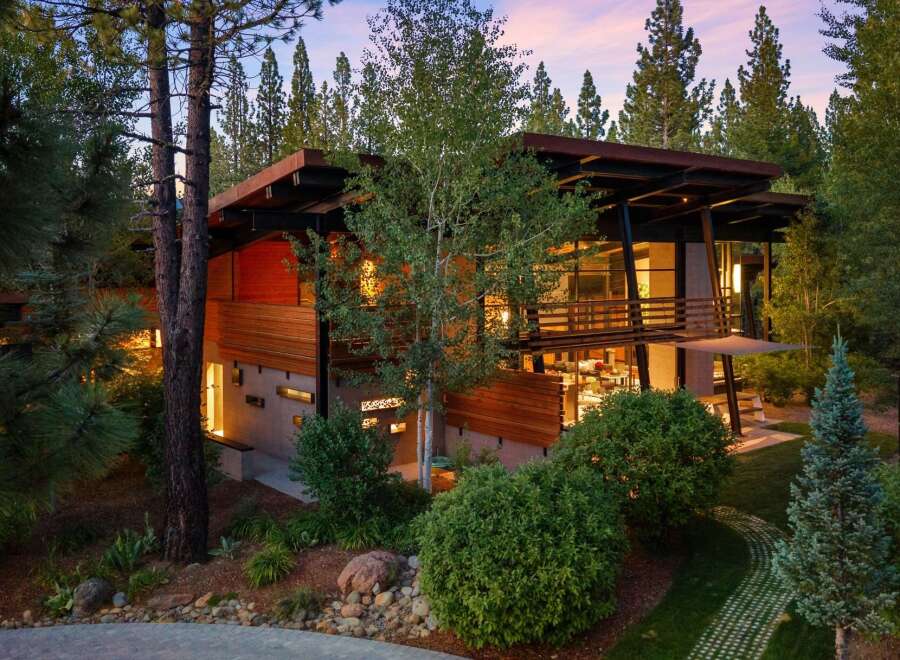 Experience modern luxury in this stunning contemporary home nestled amongst towering trees.