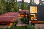 Experience modern mountain living in this stunning architectural home, nestled amidst towering pine trees and overlooking a picturesque hillside.