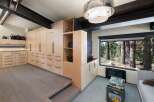Experience unparalleled luxury and organization in this stunning modern home, featuring custom floor-to-ceiling cabinetry that maximizes storage and enhances the sleek aesthetic.