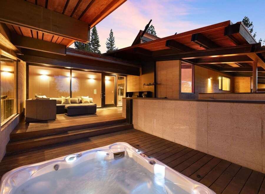 Experience ultimate relaxation in this stunning modern home featuring a luxurious outdoor hot tub perfect for unwinding under the stars.