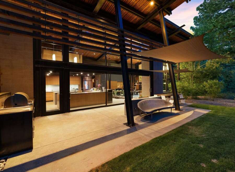 Experience seamless indoor-outdoor living with this stunning modern home, featuring a spacious patio perfect for entertaining.