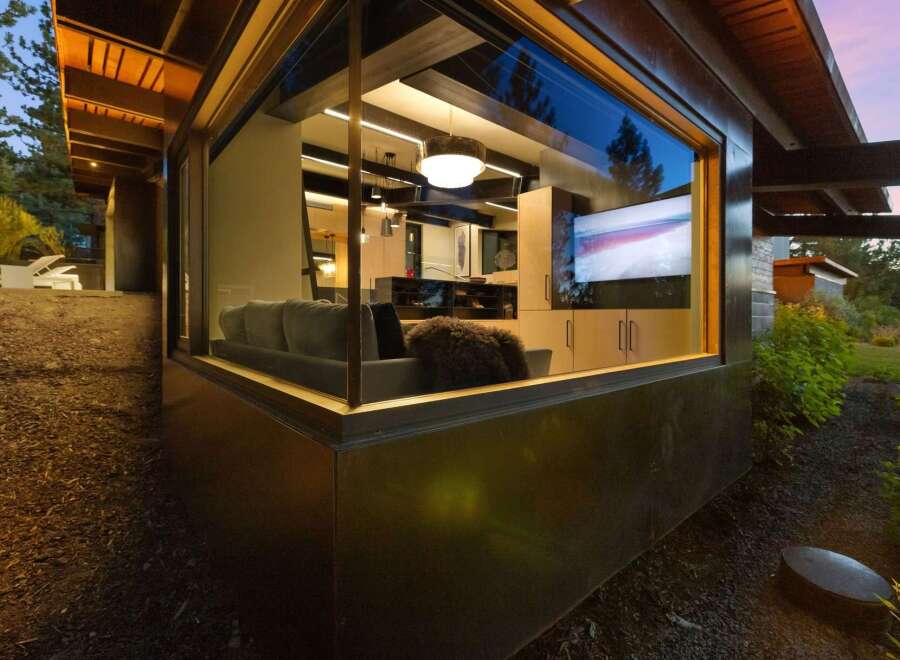 Experience modern living with this stunning home featuring a large picture window that seamlessly blends indoor and outdoor spaces.