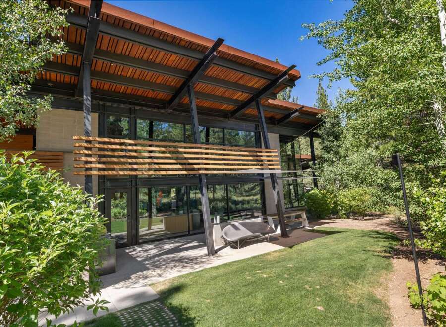 Experience modern mountain living in this stunning architectural home, featuring expansive glass walls that seamlessly blend indoor and outdoor spaces.