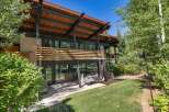Experience modern mountain living in this stunning architectural home, featuring expansive glass walls that seamlessly blend indoor and outdoor spaces.