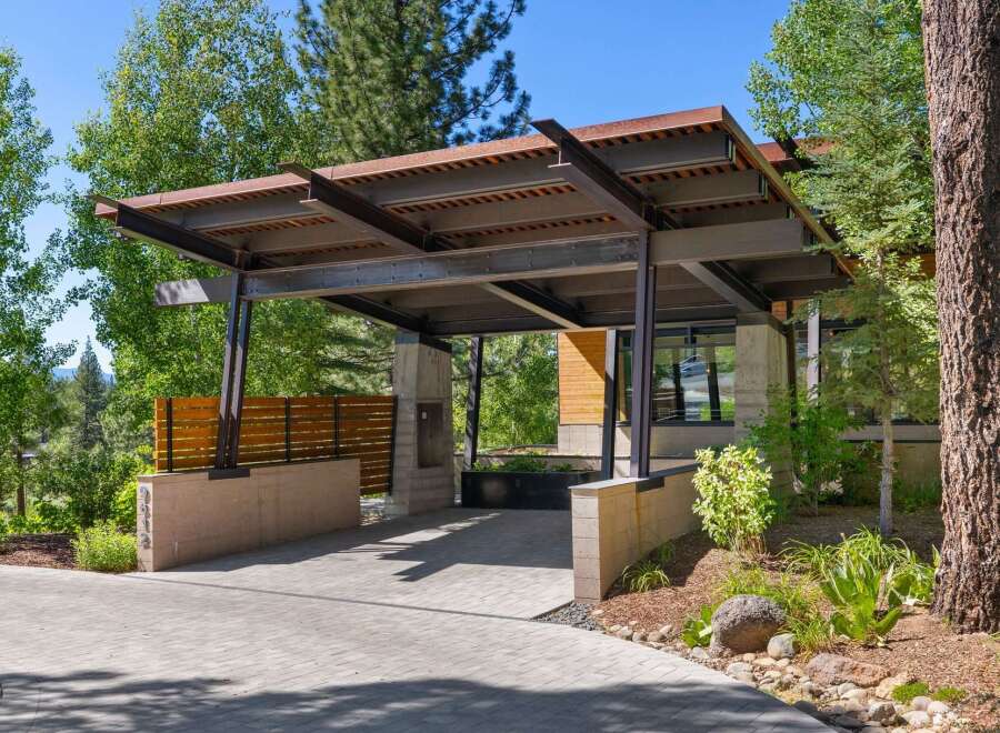 Experience modern luxury with this stunning property featuring a unique steel and wood carport structure.