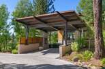 Experience modern luxury with this stunning property featuring a unique steel and wood carport structure.