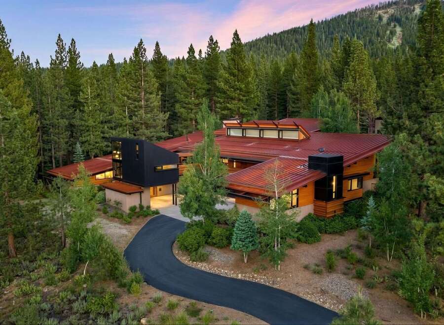 Experience luxury mountain living in this stunning contemporary home nestled amidst a serene pine forest.