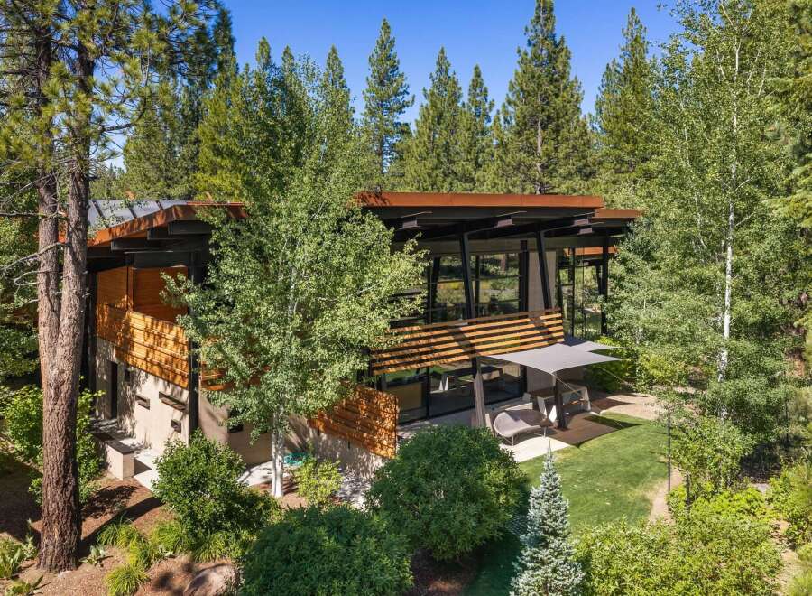 Experience modern mountain living in this stunning architectural home nestled amongst towering pine trees.
