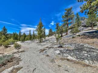 Explore the natural beauty of this stunning property, featuring a scenic trail winding through a picturesque landscape.