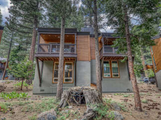 Nestled in a serene, wooded setting, this stunning property offers a perfect blend of modern design and natural beauty.