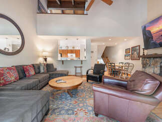 This stunning living space boasts a cozy sectional sofa, perfect for relaxing.