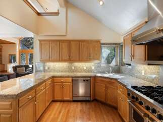 This stunning kitchen boasts custom cabinetry, granite countertops, and top-of-the-line appliances.
