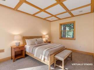 This inviting bedroom showcases a cozy ambiance with its neutral color palette and natural wood accents.