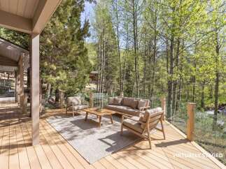 Enjoy the tranquility of nature from this stunning outdoor living space.