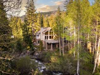 Nestled amidst a lush forest, this stunning property offers a serene retreat with breathtaking views.
