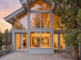 This stunning property boasts a modern design with expansive windows that flood the interior with natural light.