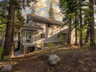 Nestled amidst towering trees, this stunning property offers a serene escape.