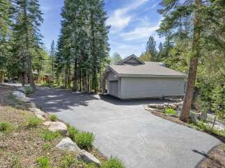 Nestled amidst towering trees, this property offers a serene escape.