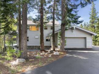 Nestled amidst towering trees, this stunning property offers a serene escape.