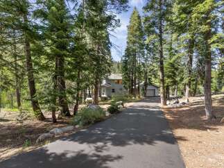 Nestled amidst towering trees, this stunning property offers a serene escape.