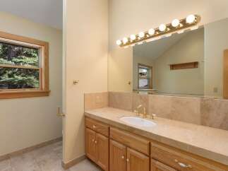 This stunning bathroom boasts a bright and airy feel, perfect for starting your day.