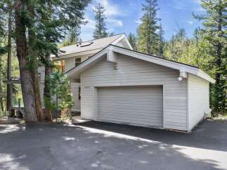 Nestled amidst towering trees, this charming property offers a serene escape.
