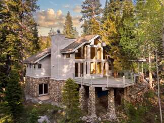 Nestled amidst towering trees, this stunning home offers a serene escape.