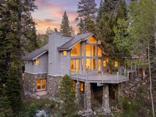Nestled amidst a serene forest, this stunning property boasts a unique architectural design with a blend of stone and wood elements.