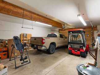 This spacious garage offers ample room for vehicles and storage, perfect for homeowners seeking extra space.