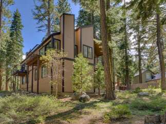 Nestled amidst towering trees, this stunning property offers a serene escape.