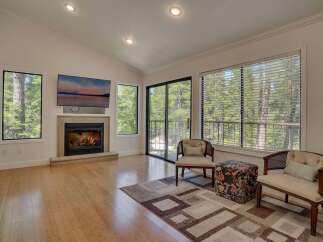 Experience the warmth of this inviting living space, featuring a cozy fireplace and a stunning view.
